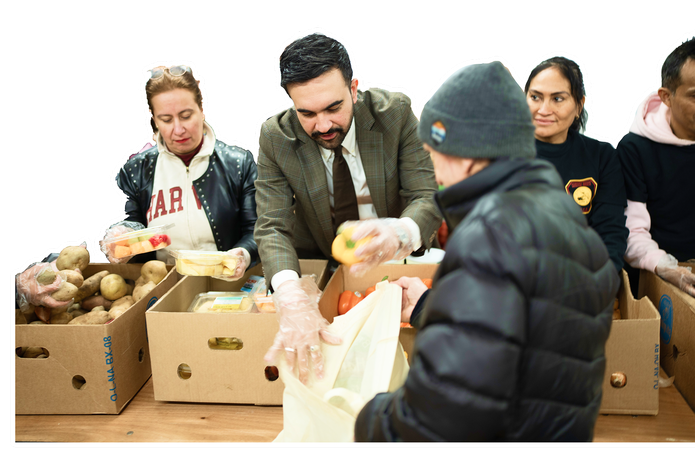 Volunteers handing out food at a distribution site